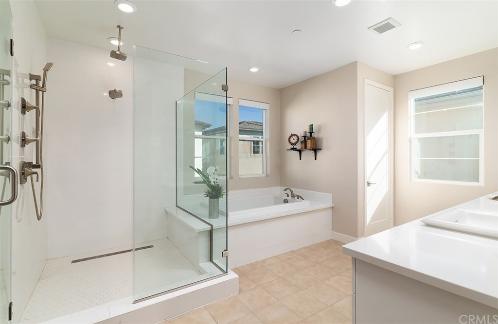 67 Swift Irvine, CA 92618 - Photo 11 of 44 Frameless shower enclosure with full-height ceramic tile surround
and decorative tile floor