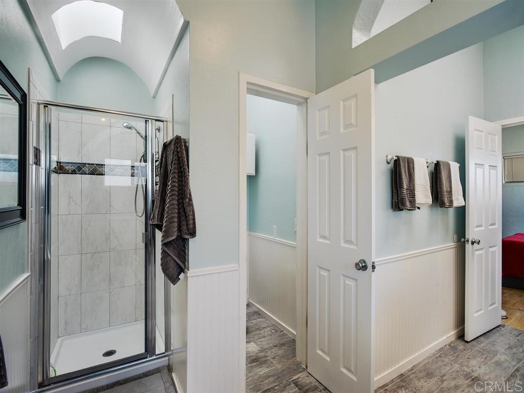 869 Beryl Street San Diego, CA 92109 - Photo 13 of 25 Master bathroom has new dual-sink vanity, walk in shower, separate water closet, and side-by-side laundry.