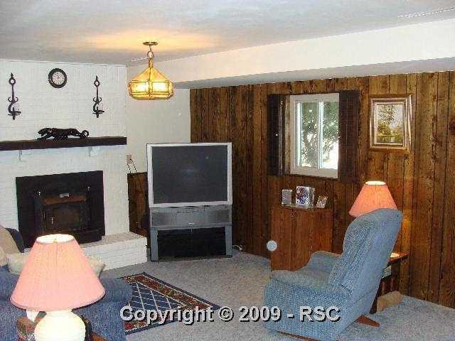 28 Mountain View Road Manitou Springs, CO 80829 - Photo 5 of 12 Comfortable Family Room with fireplace view 1