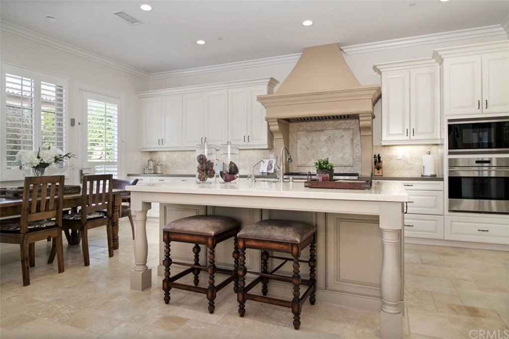 17 Rawhide Irvine, CA 92602 - Photo 4 of 56 Light and bright kitchen with caesarstone island with barstool seating. High-grade painted and glazed cabinetry, gorgeous decorative backsplash, with plenty of countertop and storage, including walk-in pantry. Top of the line stainless steel wolf and sub-zero kitchen appliances.