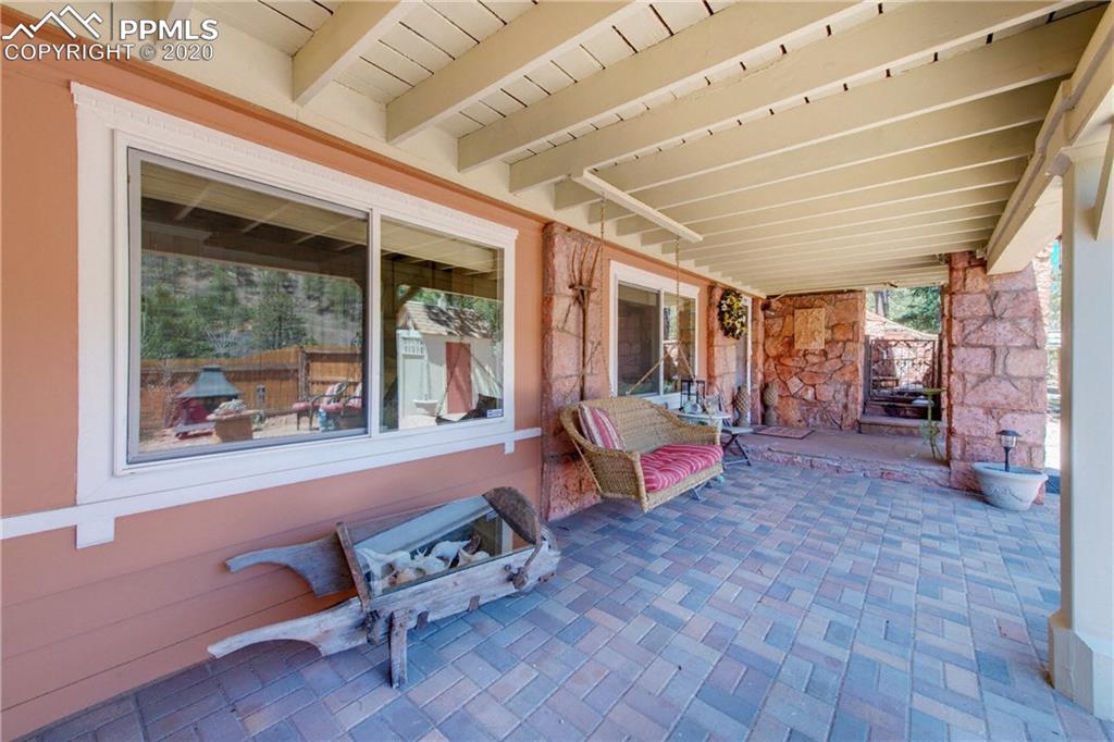 7955 Highway 24 Cascade, CO 80809 - Photo 34 of 36 Covered patio with porch swing