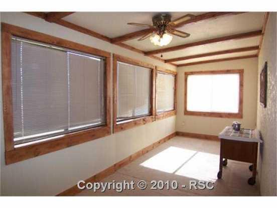 2140 Slocum Road Peyton, CO 80831 - Photo 7 of 16 The Sun Room is handy for an extra Family Room, Hobbies, or Exercise Room!
