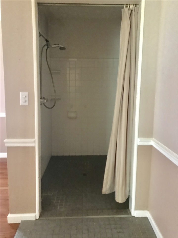 1627 Peace Chapel Road Decaturville, TN 38329 - Photo 19 of 25 Large tiled shower. Unusal layout the commode and vanity is separate. This shower was done so a wheel chair could be rolled in. It is located in the Bedroom