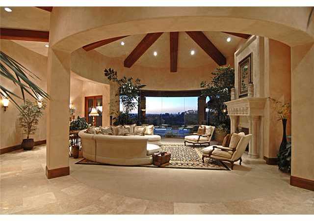 6890 St Andrews Road Rancho Santa Fe, CA 92067 - Photo 2 of 15 Very unique walls of glass set the tone for the formal living room, while overlooking the vanishing edge pool and views of the golf course.