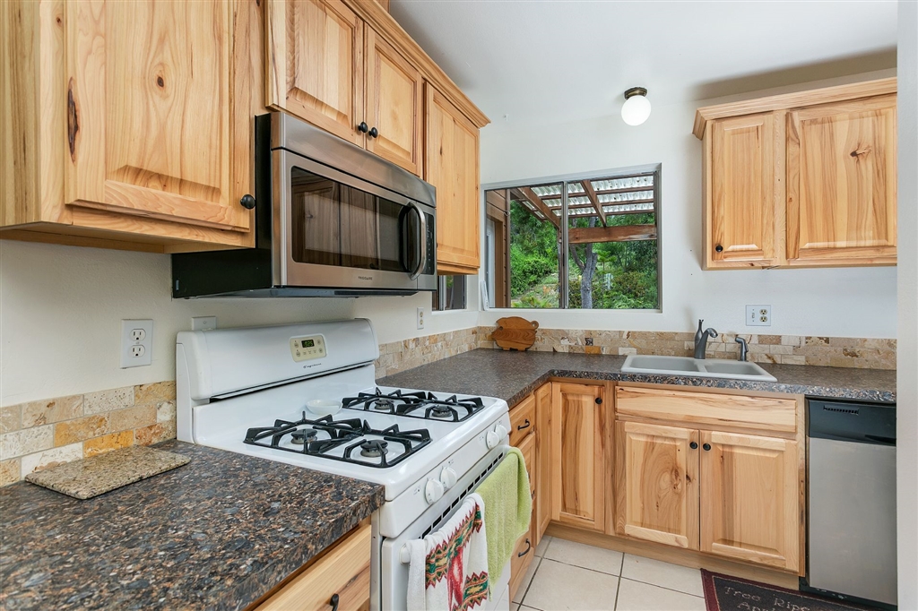 1387 Peacock Boulevard Oceanside, CA 92056 - Photo 6 of 15 Upgraded kitchen with natural hickory cabinets and newer appliances.