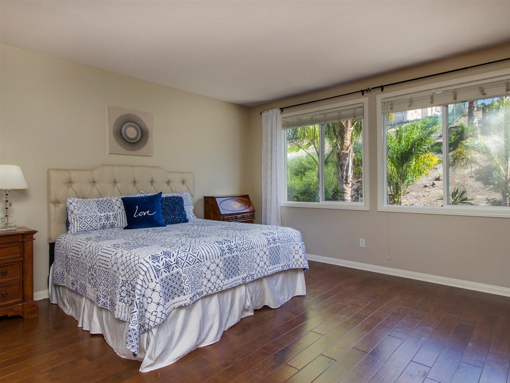 1267 Mariposa Road Carlsbad, CA 92011 - Photo 13 of 25 The spacious master bedroom has wide-plank hardwood floors and plenty of space for a sitting area.