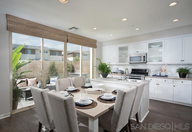 2097 Tango Loop, Unit 2 Chula Vista, CA 91915 - Photo 4 of 20 Fantastic kitchen next to outdoor space with huge slide to yard area. Pictures are of model home