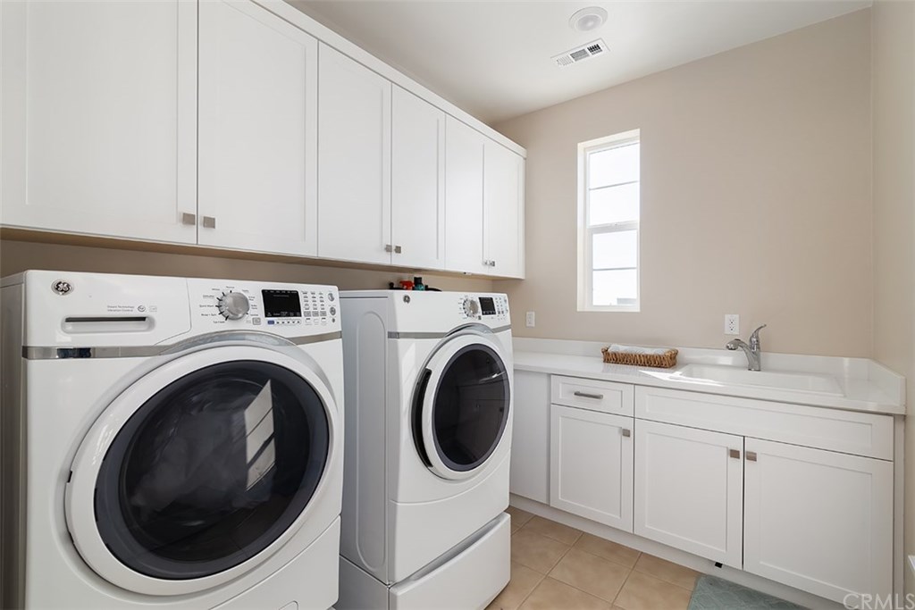 67 Swift Irvine, CA 92618 - Photo 21 of 44 Quite laundry room with sink, and room for Fold & Hide