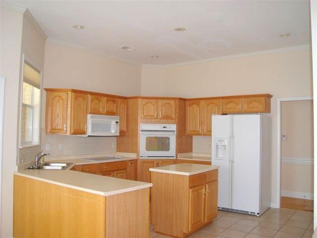 Spacious kitchen w/island, lots of cabinets and large pantry.