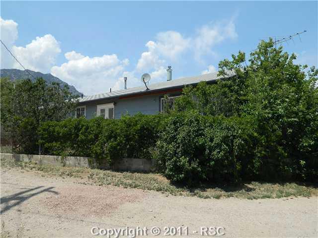 225 Pawnee Road Colorado Springs, CO 80926 - Photo 10 of 16 Lots of privacy in the back yard. Fenced around immediate back yard, lots of flowers/vines on fence that gives the back patio area privacy. View of mountains.