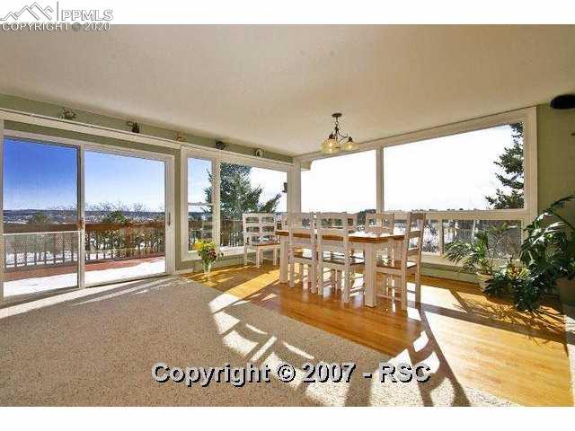 18385 Pixie Park Road Monument, CO 80132 - Photo 6 of 13 Dining Room Surrounded by Windows to Enjoy the Views. Hardwood Flooring.