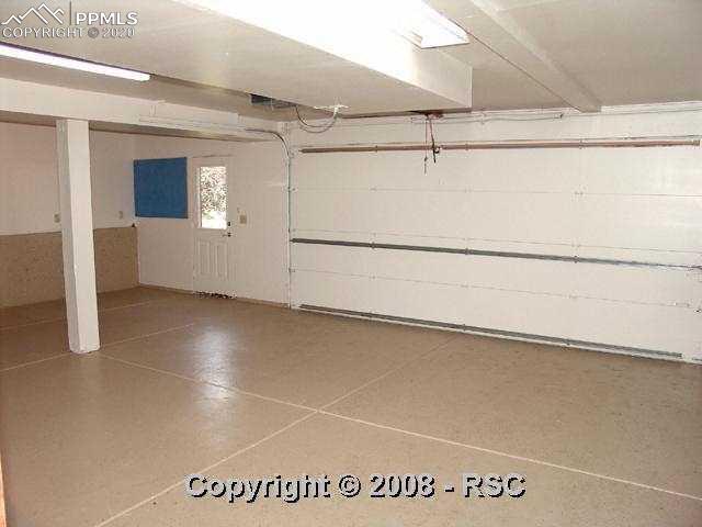 8025 Swan Road Colorado Springs, CO 80908 - Photo 9 of 15 Immaculate oversized 2 1/2 car garage with epoxy floor.