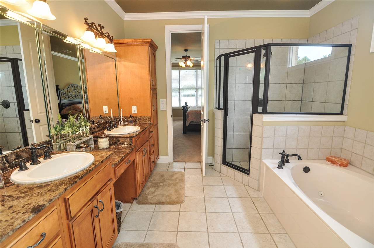 345 Windover Road Piperton, TN 38017 - Photo 12 of 25 The luxury master bath comes with a large vanity with dual sinks & granite tops, tile floor, walk-in shower, jetted tub, and a huge walk-in closet with custom built-in shelving & dresser.
