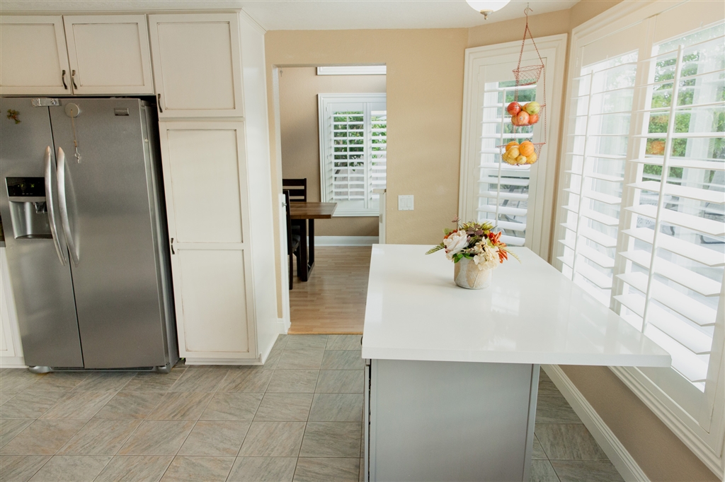 2105 Madiera Drive Oceanside, CA 92056 - Photo 20 of 25 Enjoy making a delicious dinner in this bright and modern, recently renovated kitchen, featuring upgraded new kitchen cabinets, quartz countertops, recessed lighting, tile floors and a matching kitchen island that is easy to move.