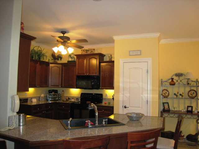 1892 Ready Drive Hernando, MS 38632 - Photo 4 of 9 Cooking will be fun in this kitchen! Great cherry cabinets with under lights, brushed nickle hardware, a stove with a warming area, a ceiling fan, and a deep sink for easy clean-up!