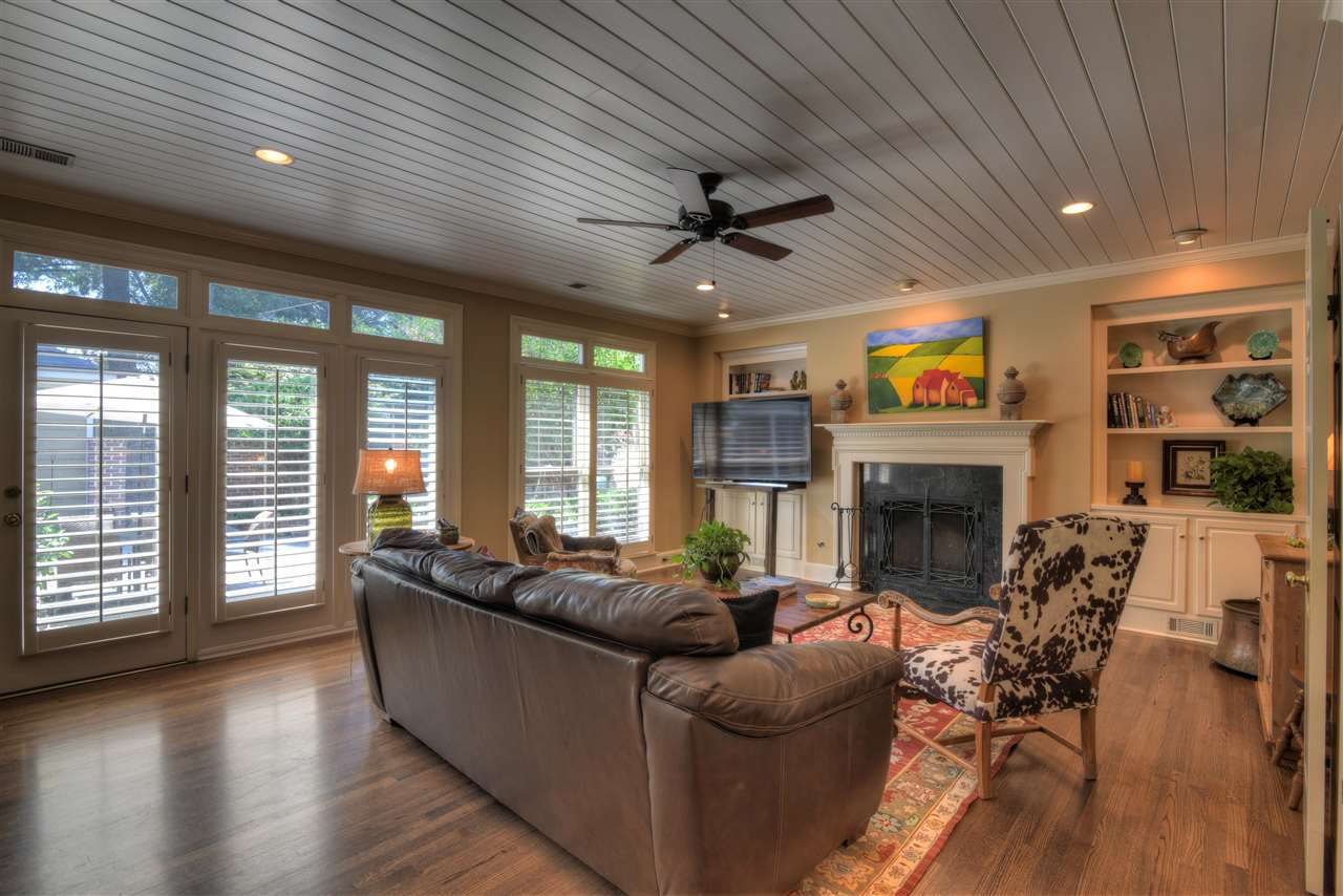 5249 Lexington Road Memphis, TN 38120 - Photo 10 of 25 Light-filled den/great room boasts fireplace, plank ceiling, exterior French doors, built in shelves and cabinets, and ceiling fan fixture.