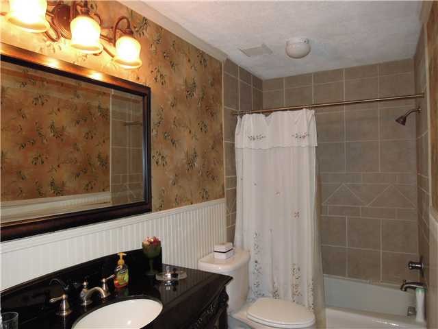 505 Poplar Acres Road Piperton, TN 38017 - Photo 9 of 12 Updated Bath with Furniture Piece, New Hardware,Mirror, Lighting, Tile Surround, Bead Board! Its Cute..
