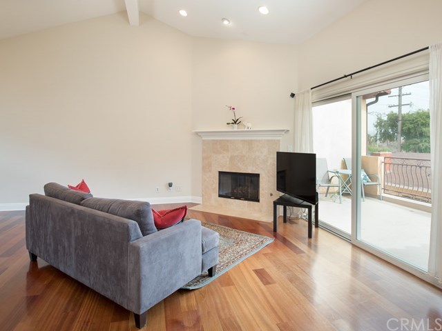 2302 Grant Avenue, Unit 2 Redondo Beach, CA 90278 - Photo 9 of 29 Living room welcomes a stylish fireplace with vaulted ceilings and recessed lighting.