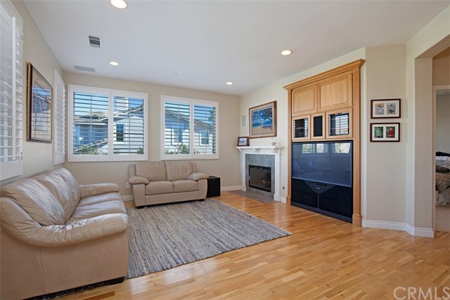 605 Corte Calmo San Clemente, CA 92673 - Photo 5 of 27 Living room with entertainment center and fireplace.
