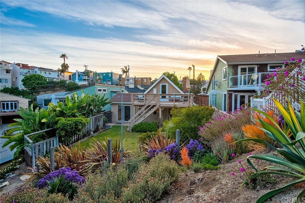 34096 El Contento Dana Point, CA 92629 - Photo 27 of 43 View from the back toward the master bedroom overlooking the meticulously maintained lawn, landscaping and ocean views with tinted concrete, lighting and privacy!