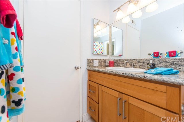 131 Remington, Unit 239 Irvine, CA 92620 - Photo 27 of 36 Hall bath has been remodeled with newer cabinetry, granite counters and newer fixtures!