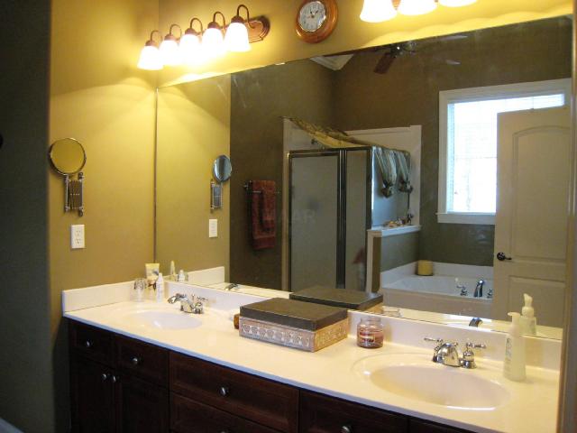 1892 Ready Drive Hernando, MS 38632 - Photo 8 of 9 Relax in your master bath! The really tall ceiling hosts a ceiling fan. There is a separate shower, lots of storage and drawer space in the double vanity, good lighting, and a jacuzzi tub for TWO!