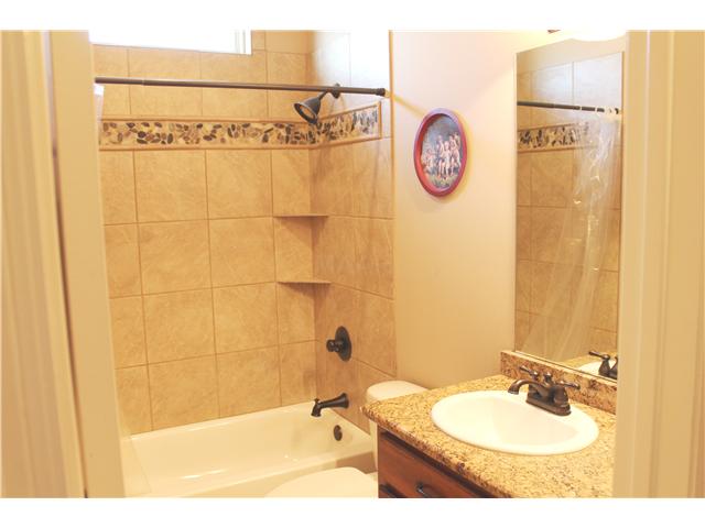 466 Leta Loop Brighton, TN 38011 - Photo 15 of 25 Downstairs bath between 2 bedrooms with more granite and pay attention to the detail in the tile shower surround!