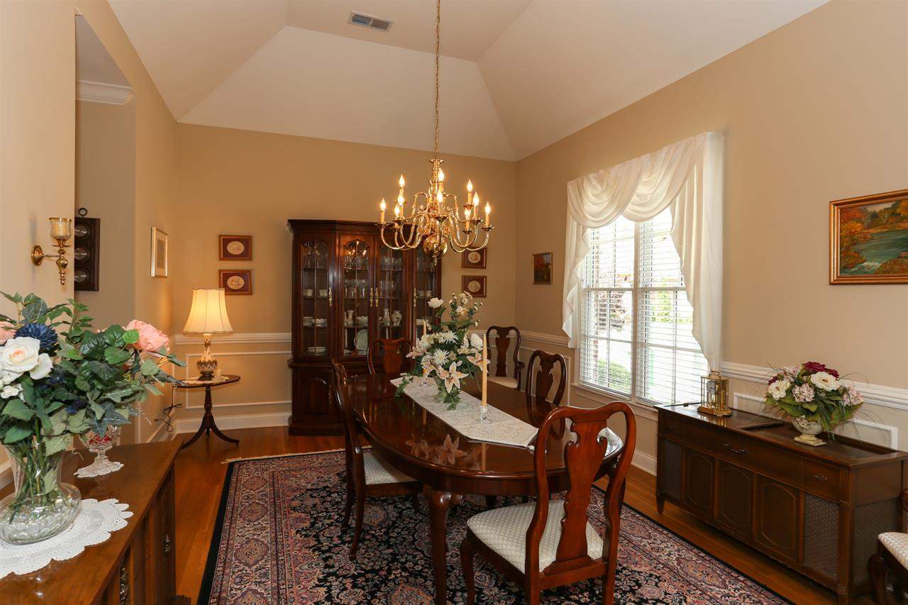 Very spacious dining room is perfect for entertaining! Tall coffered ceilings and large double windows make this the perfect setting for family meals!