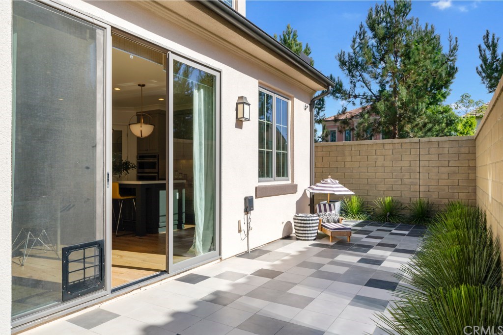 116 Mosswood Irvine, CA 92620 - Photo 30 of 42 The wrap-around backyard features over $15k in upgrades, including custom-tile flooring, contemporary desert landscaping, artificial turf and concrete paving.
