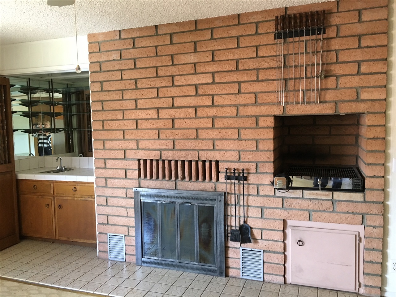 2202 M And R Ranch Road Fallbrook, CA 92028 - Photo 7 of 25 Family room off kitchen has a fireplace and BBQ.