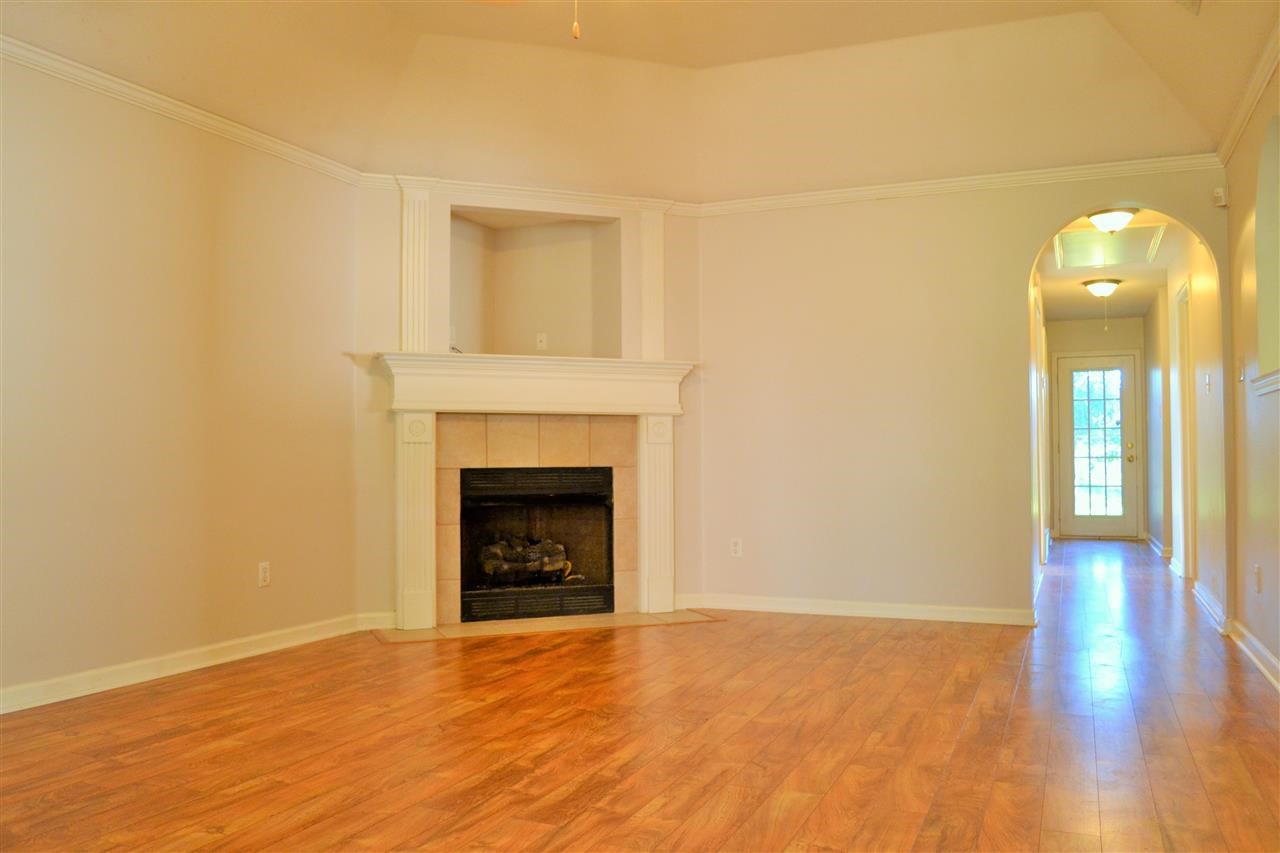10072 Cross Ridge Road Cordova, TN 38018 - Photo 4 of 25 Spacious Great room with Stunning wide plank laminate floors, a beautiful corner fireplace, and tall vaulted ceilings!