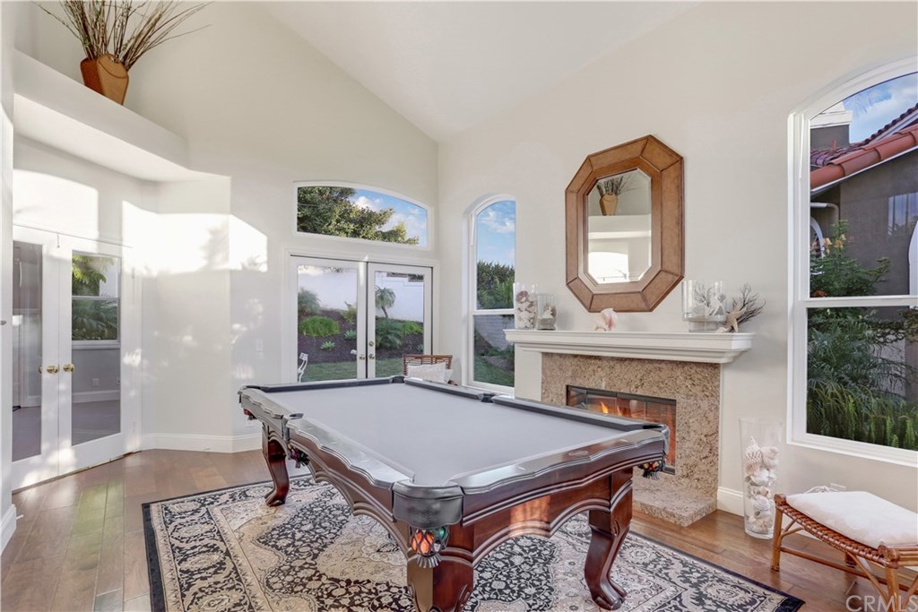 6 Via Colorso San Clemente, CA 92672 - Photo 5 of 32 Elevated ceilings, french doors, lots of bright light enters through windows, fireplace creates a cozy space.