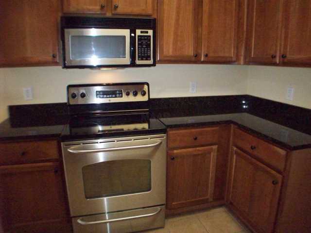 26 Peyton Ridge Drive, Unit 22 Collierville, TN 38017 - Photo 5 of 12 Gorgeous cabinetry, granite counter tops, tile floor and stainless steel appliances round out this well appointed kitchen with breakfast bar overlooking the great room. The kitchen is plumbed for gas cooking too!