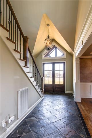 6545 Eudailey-Covington Road College Grove, TN 37046 - Photo 3 of 30 A formal foyer, with full slate floors and distinguished double doors, boasts an architecturally distinctive ceiling that sets off the elegant chandelier. Open walls at the top of the front stairs show off the massive exposed beams in the Great Room.
