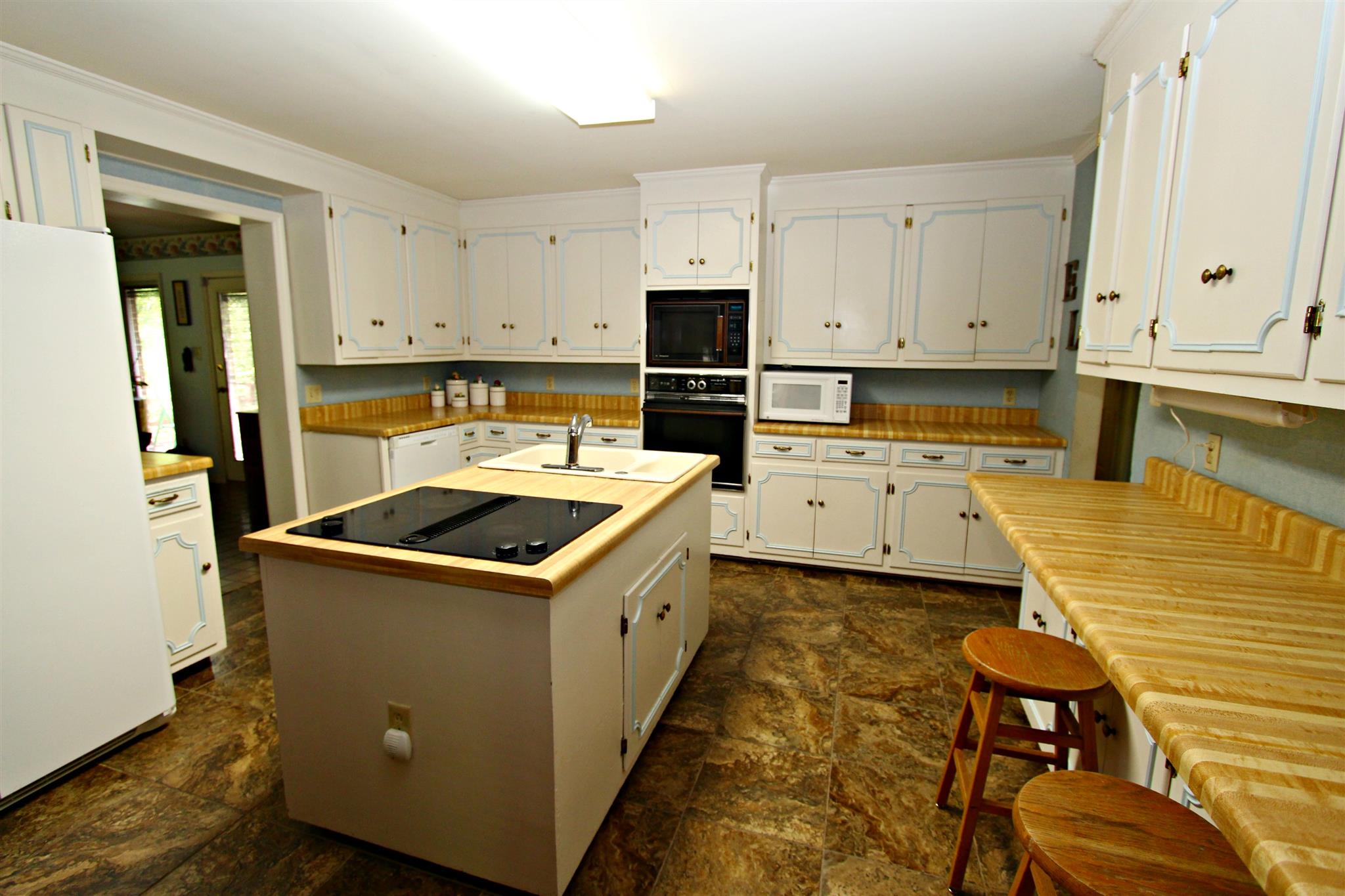 300 Kippsford Pond Road Columbia, TN 38401 - Photo 14 of 36 Square-shaped kitchen features lots of cabinets and counter tops.