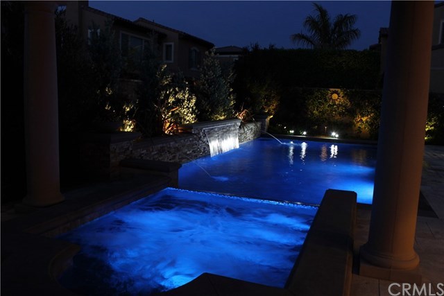 17 Rawhide Irvine, CA 92602 - Photo 37 of 56 Top of the line salt water pool features large waterfall, LED lights, connected jacuzzi spa covered by outdoor structure. High end equipment (Pentair and Jandy) with mobile app control of pool features. Cost of private luxury is kept low with 12-panel 3.7 kilowatt solar power ($125 average electric bill including heating and use of pool features).