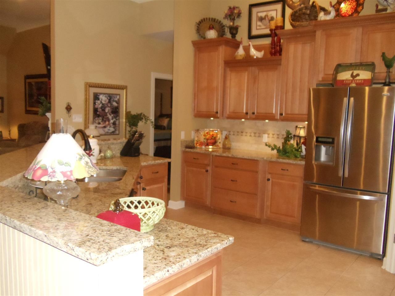Completely Renovated Kitchen... features include tile floors & backsplash, stainless appliances, staggered cabinets, Granite countertops,  built-in microwave, smooth top stove, double oven, & pantry.