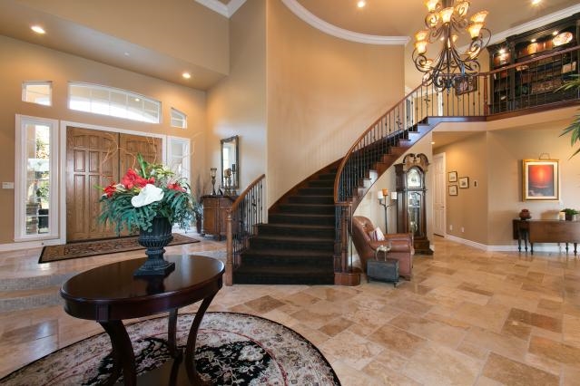 512 Latigo Row Encinitas, CA 92024 - Photo 3 of 25 Vastly upgraded throughout with wood & travertine floors, wrought iron staircase, crown molding, wood cased windows, coffered ceilings, stone finishes & more!