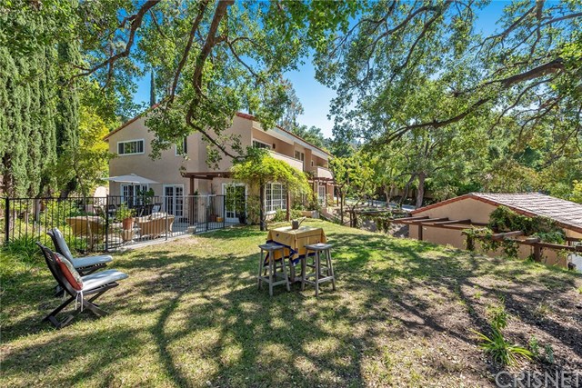 Set back behind a long driveway,  on a private knoll, with abundant grassy areas and mature trees.