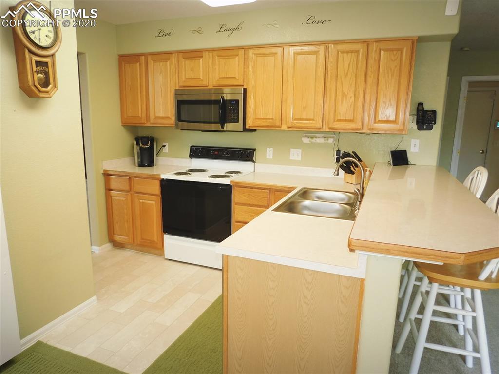 6565 Quarter Circle Road Colorado Springs, CO 80922 - Photo 6 of 21 Kitchen with breakfast bar