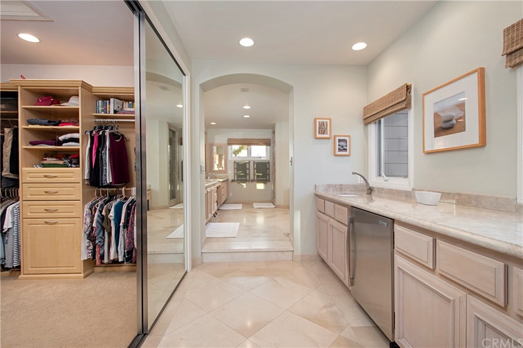 23 Emerald Glen Laguna Niguel, CA 92677 - Photo 32 of 56 Master suite hall to bathroom with sink and mini fridge