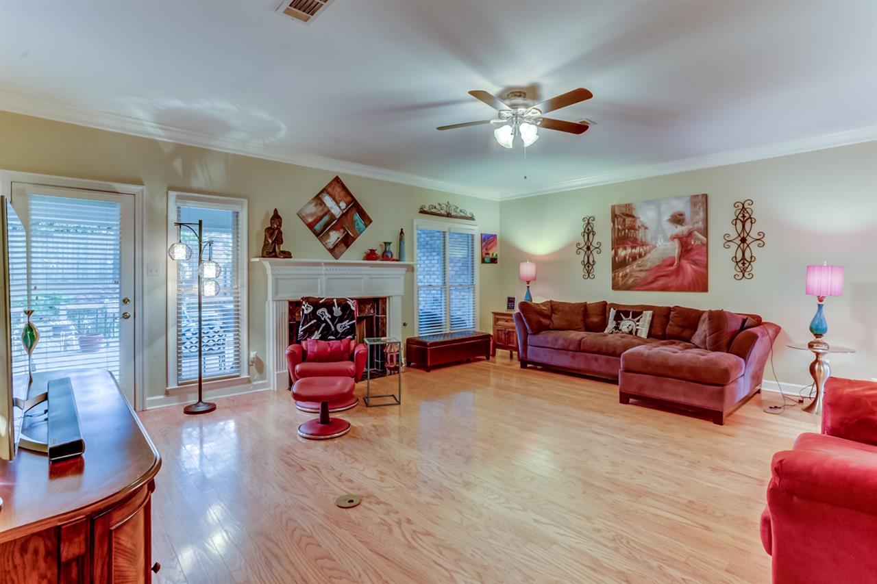 6846 Tree Spring Cove Bartlett, TN 38135 - Photo 12 of 25 The spacious great room is the perfect place to entertain and relax. This room features gleaming wood floors, crown molding, a cooling ceiling fan, and a cozy fireplace perfect for those cozy nights at home.