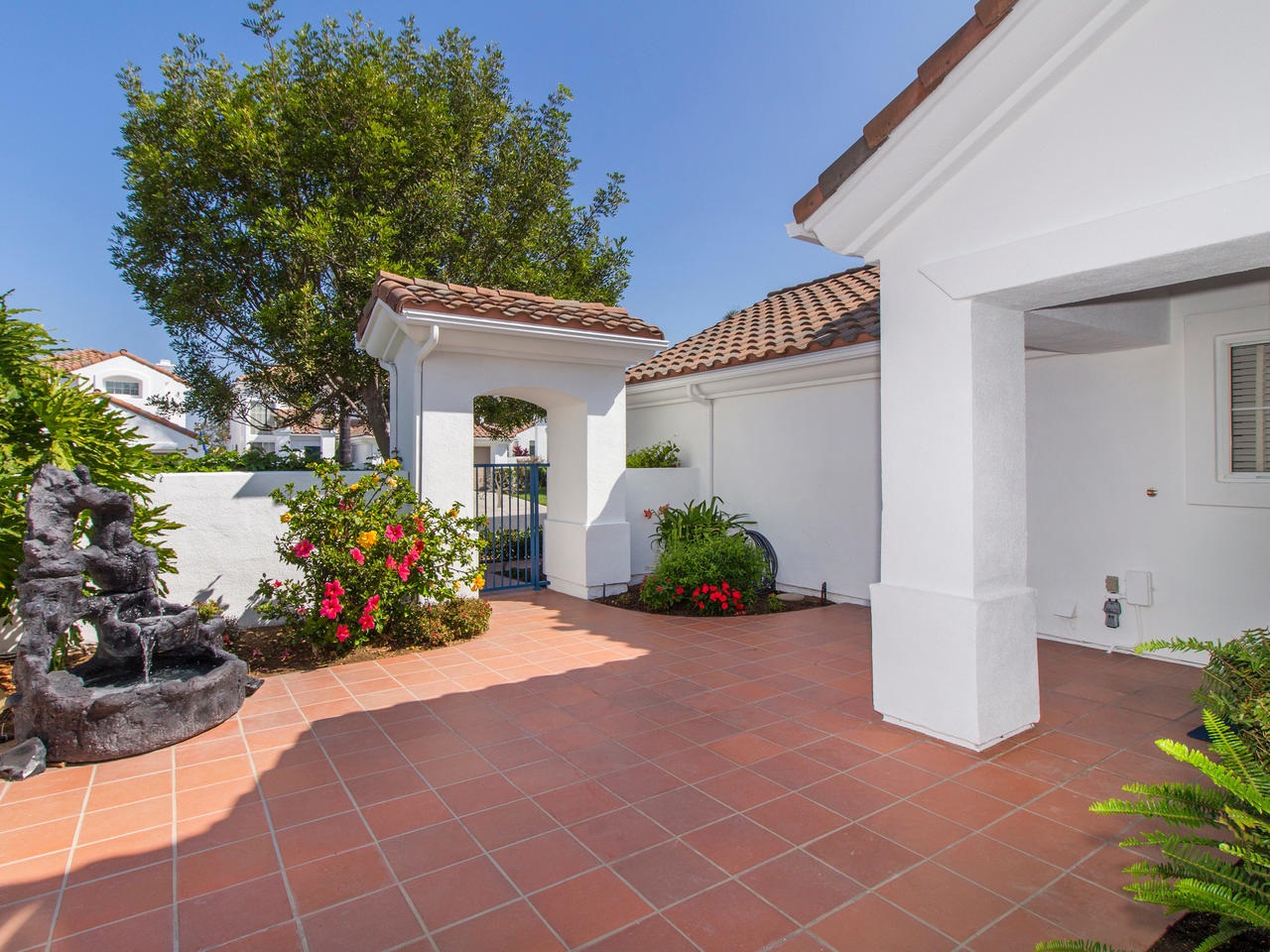 6047 Piros Way Oceanside, CA 92056 - Photo 2 of 25 The home has a private gated front courtyard into your own tropical paradise which includes a tranquil fountain surrounded by stunning blooming foliage.