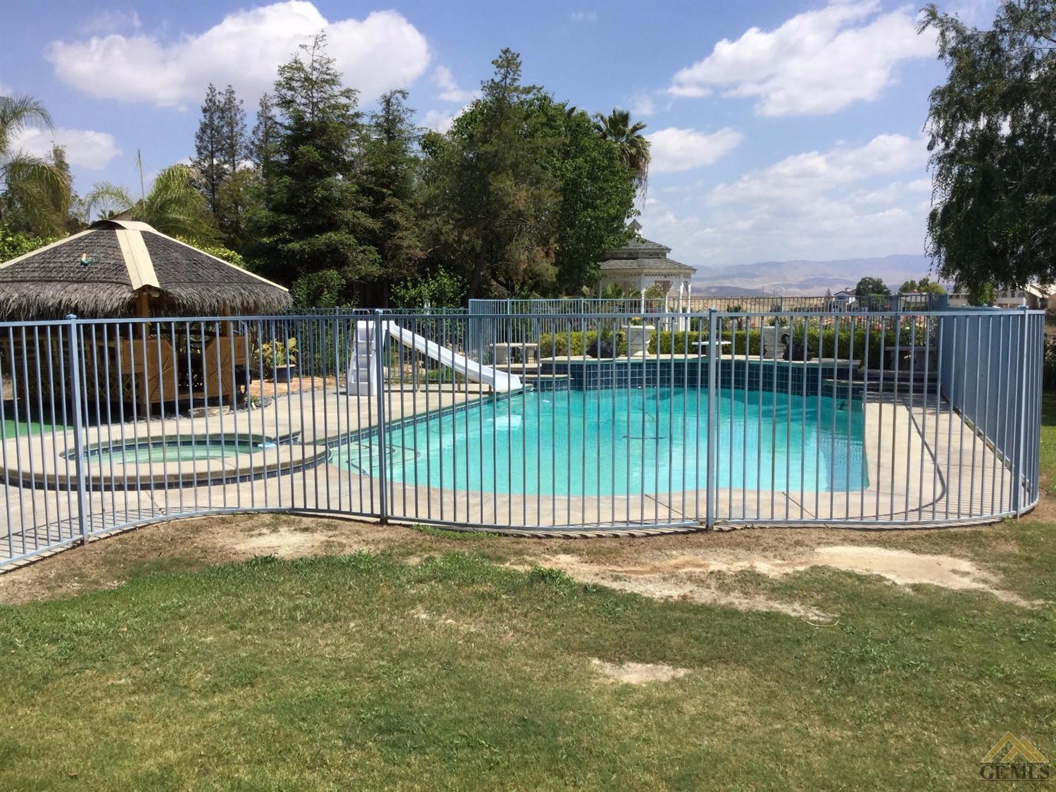 5008 Panorama Drive Bakersfield, CA 93306 - Photo 37 of 40 Sparkling pool with tiki lounge, spa, diving board and slide. Views of the mountains