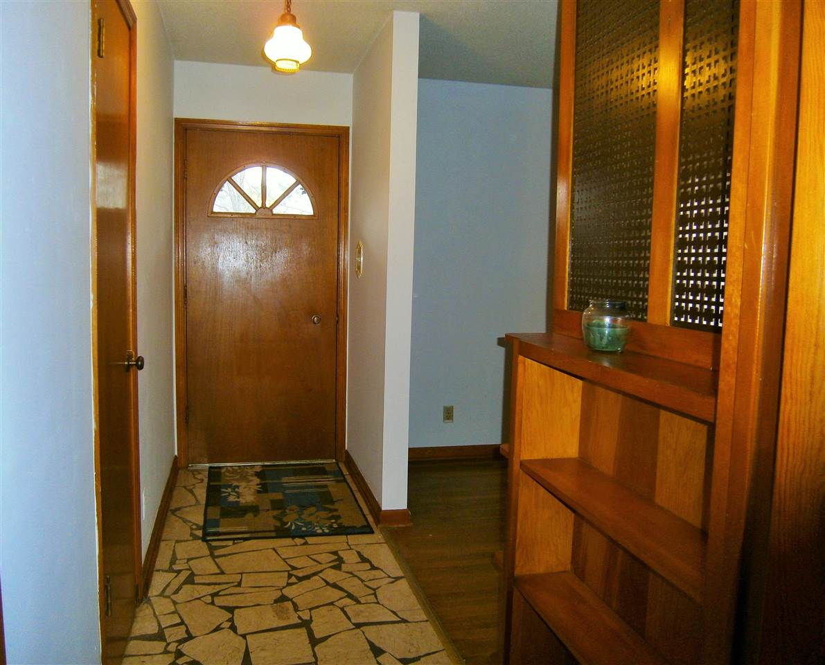 1347 Abernathy Road Memphis, TN 38116 - Photo 9 of 22 Entry way with beautiful broken tile floor and bookcase.