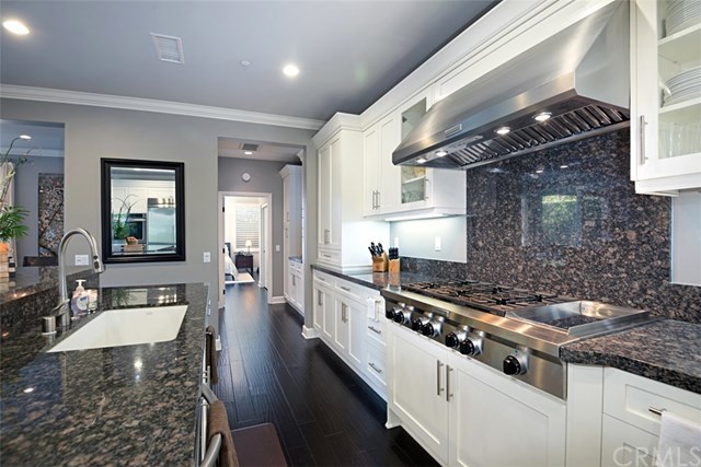 53 Livia Irvine, CA 92618 - Photo 15 of 67 Through the kitchen and past the butler's pantry is the secluded, private downstairs bedroom suite with full bathroom - perfect for visiting guests or multi-generational families.