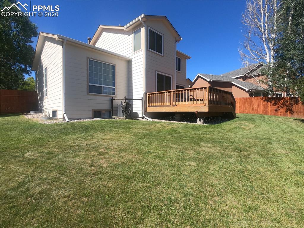 6565 Quarter Circle Road Colorado Springs, CO 80922 - Photo 3 of 21 Large backyard with new deck