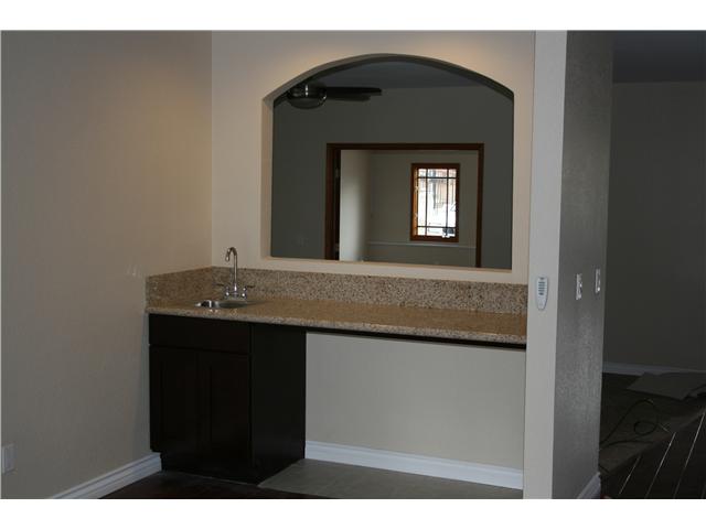9911 Tangor Way Spring Valley, CA 91977 - Photo 4 of 13 wet bar area with wine refrigerator space with granite countertops for your social events