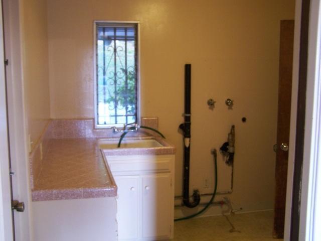 5017 New Ranch Road El Cajon, CA 92020 - Photo 5 of 15 Laundry room with built in shelves and counters. Bathroom with Shower is to the right.