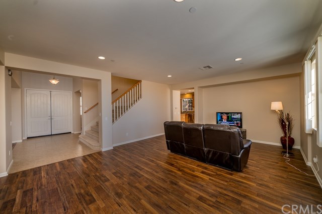 5473 Stoneview Road Rancho Cucamonga, CA 91739 - Photo 8 of 56 Large family room with new laminate flooring